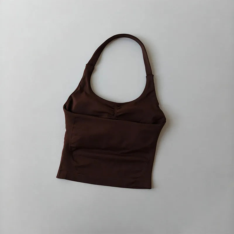 A dark brown seamless yoga and pilates sports bra displayed against a light gray background.