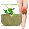 A green wormwood knee patch is applied to a person's knee area.
