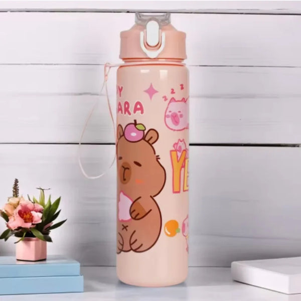 A pink water bottle shaped like a capybara with a straw and handle, standing on a white surface.