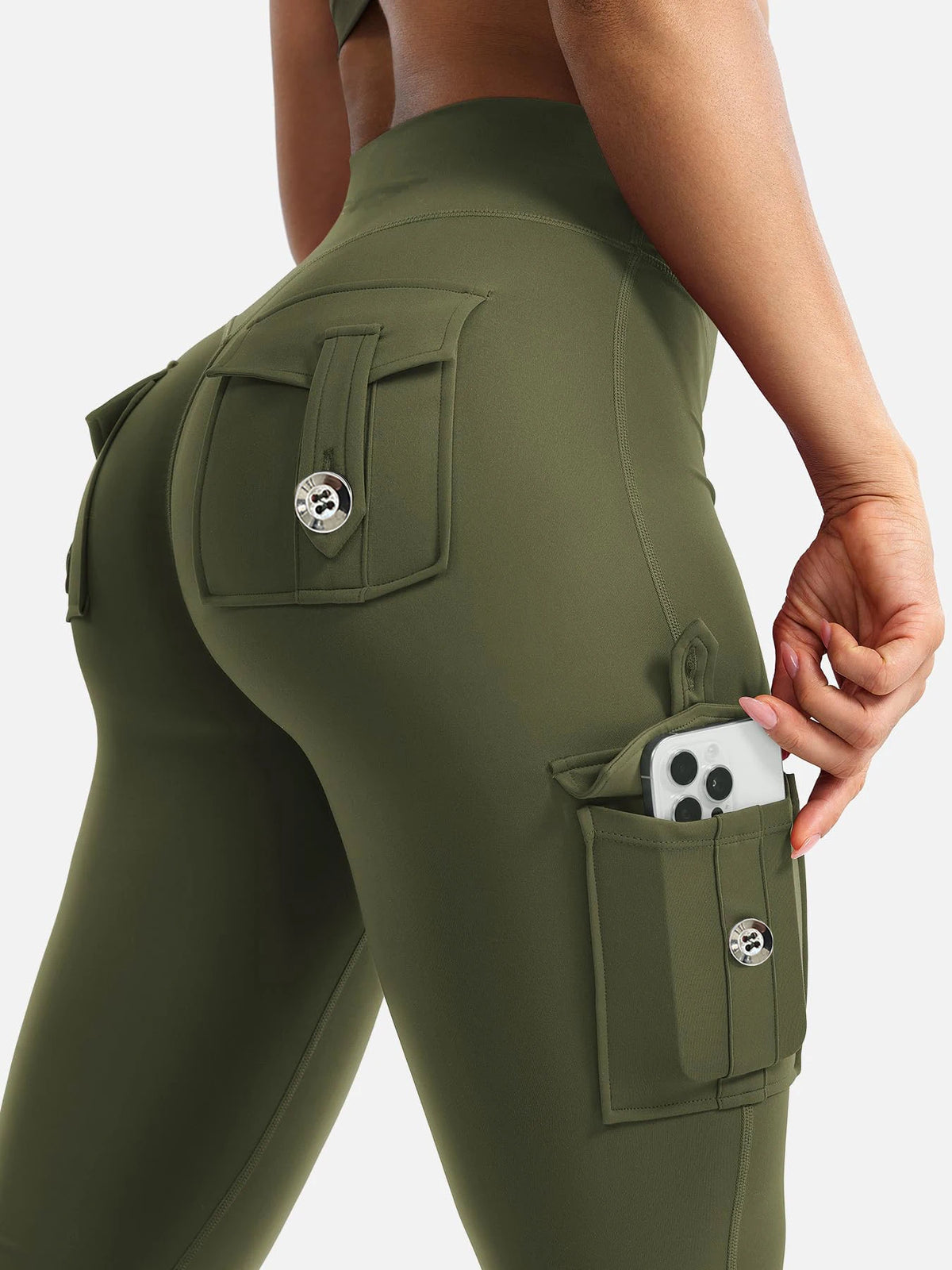 A close-up of olive green high-waisted fitness pants featuring multiple utility pockets.