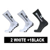 Three pairs of football socks are shown: two white and one black, featuring an anti-slip silicone grip.
