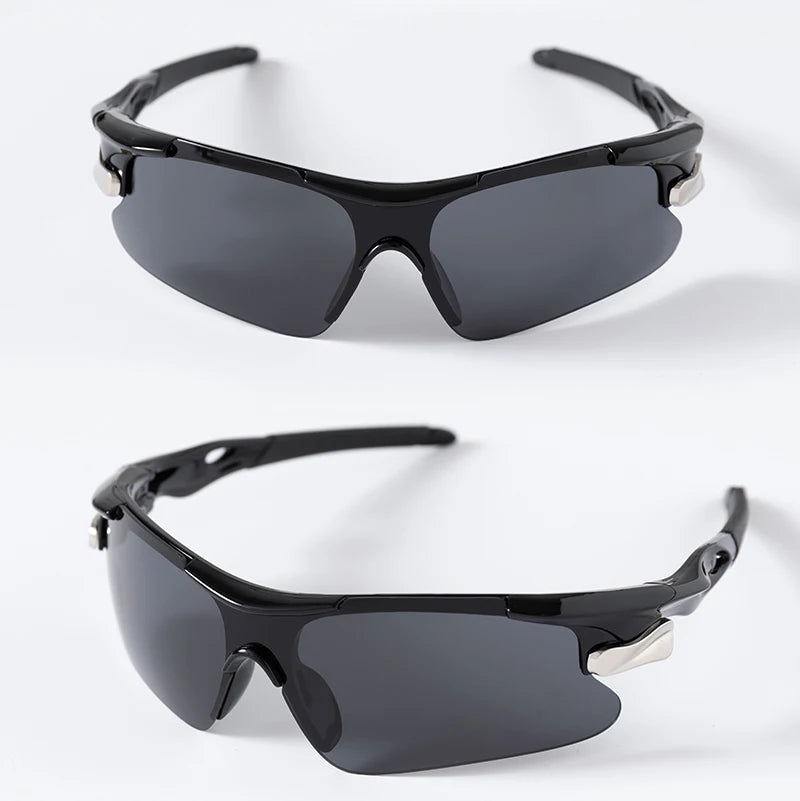 Black sport sunglasses with black frames and dark lenses shown against a white background.