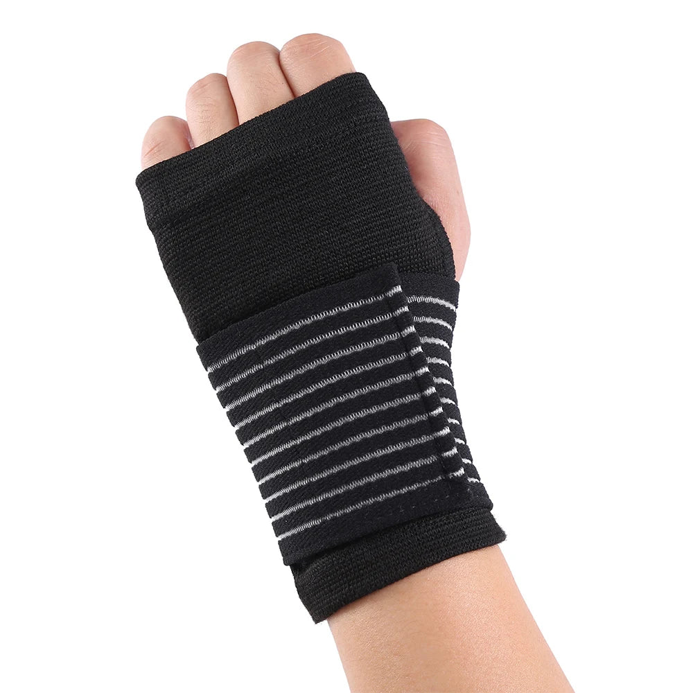Black elastic wrist support brace with gray stripes worn on a hand and wrist.
