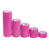 Several rolls of bright pink elastic tattoo grip tape for finger and wrist protection