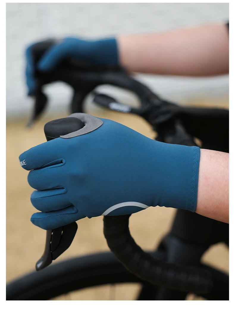A hand wearing a blue cycling glove with silicone palm pads gripping a bicycle handlebar.