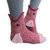 Pair of fuzzy pink knit socks with a crocodile design and red trim