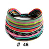 A colorful, striped knitted headband featuring pink, green, yellow, and black patterns.