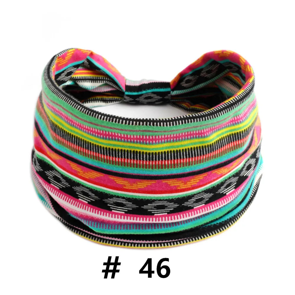 A colorful, striped knitted headband featuring pink, green, yellow, and black patterns.