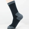 A close-up of dark gray waterproof breathable hiking socks worn on a foot.