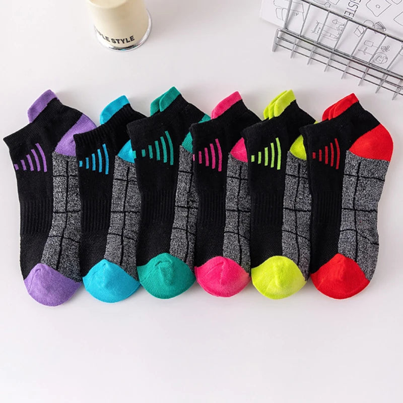 A collection of colorful knit sports socks arranged in a row on a white surface.