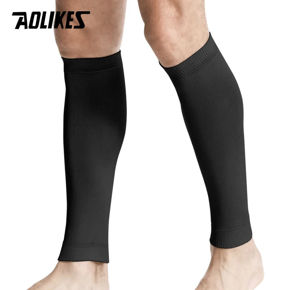 Black compression leg sleeves worn on a person's lower leg.