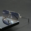 A pair of silver-framed retro double bridge aviator sunglasses resting on a dark surface.