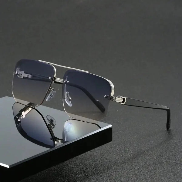A pair of silver-framed retro double bridge aviator sunglasses resting on a dark surface.