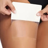 Hands are applying an invisible leg lifting patch to a person's skin.
