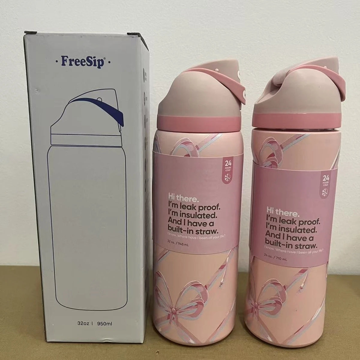 A pink vacuum insulated water bottle with a straw and a matching box are shown side by side.