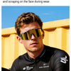 A male model wearing face-contoured lens curvature sunglasses while sitting on a bicycle.