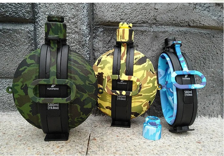 Three collapsible silicone camping kettles in camouflage, yellow, and blue colors displayed on a gray background.