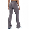 A model wearing seamless gray flared yoga leggings in a full-length shot.