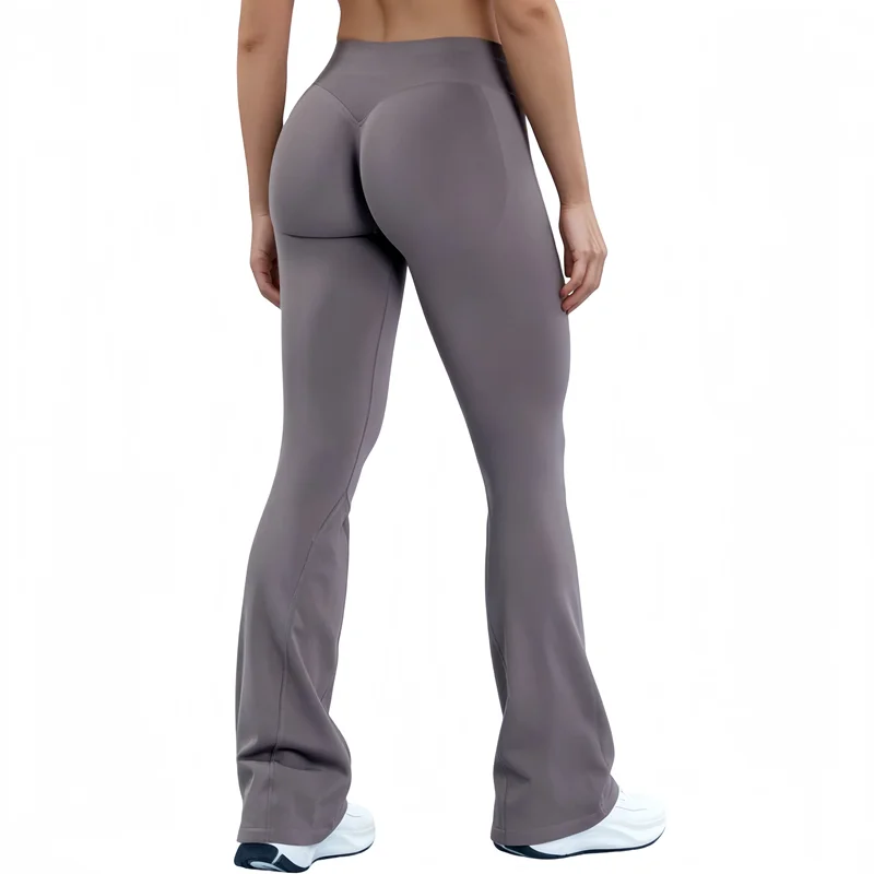 A model wearing seamless gray flared yoga leggings in a full-length shot.