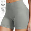 A model is wearing high-waisted gray knit fitness shorts, highlighting features like quick-dry and 4-way stretch.