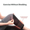 A person is wearing thick, dark gray knee warmers or leg guards designed to prevent shedding.