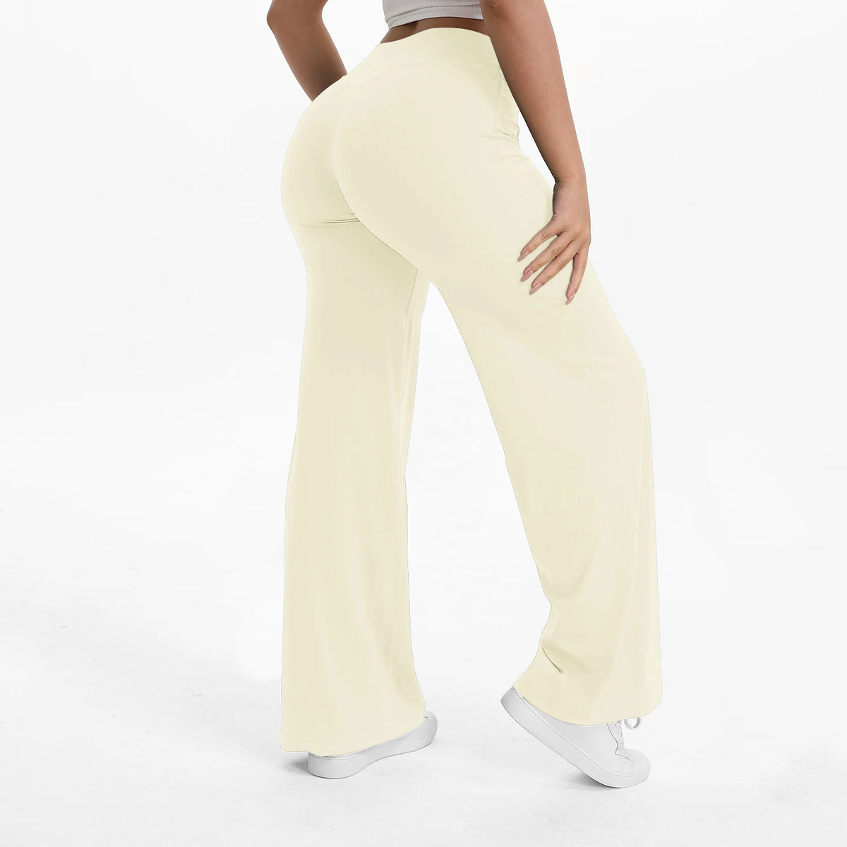 A person wearing light beige NCLAGEN SoftMotion straight leg yoga pants.