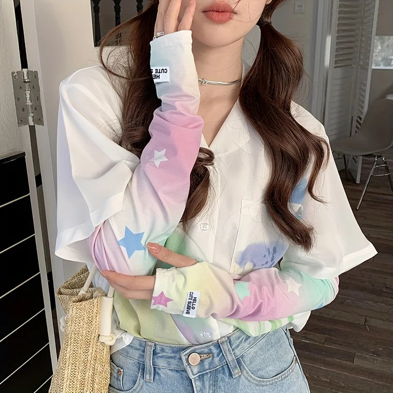 A woman wearing white clothing and floral arm sleeves with pink, purple, and yellow accents.