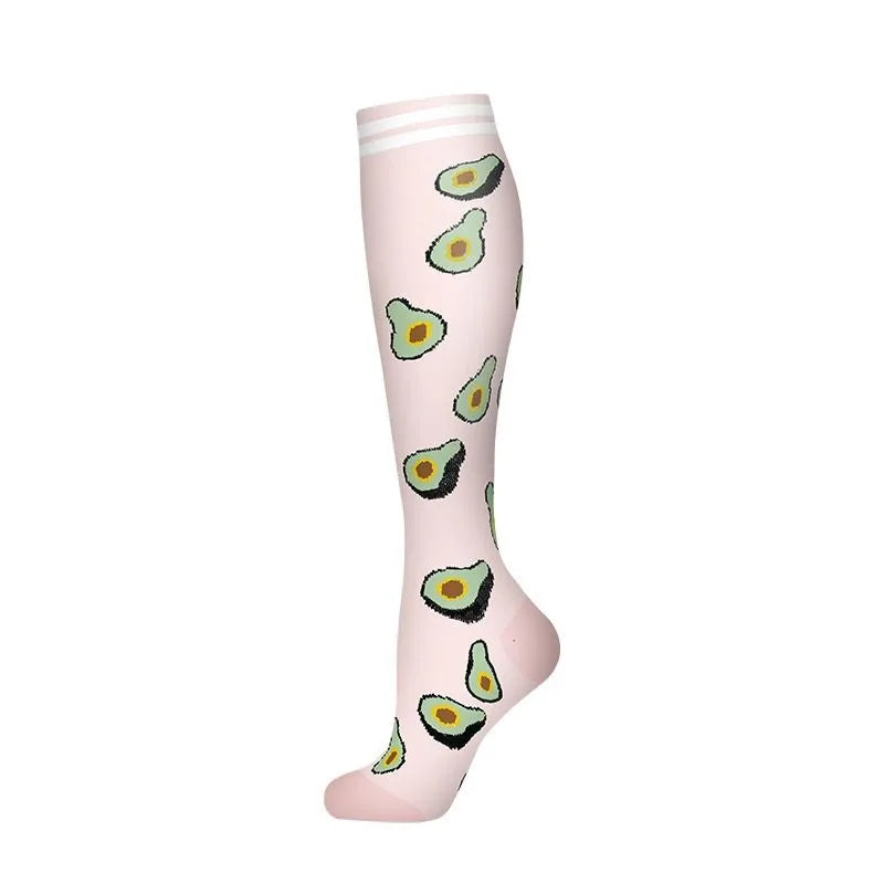 A pair of light pink compression socks featuring a pattern of sliced avocado designs.