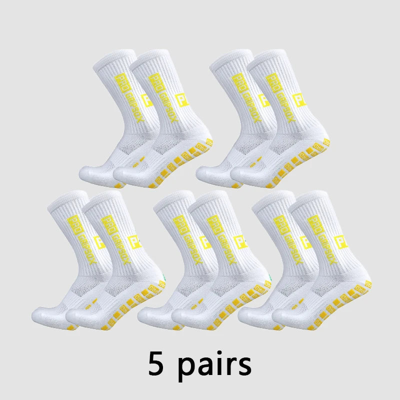 Five pairs of white and yellow anti-slip grip soccer socks displayed on a light gray background.