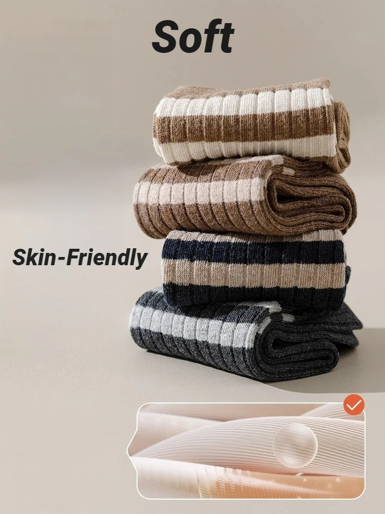 A stack of soft, skin-friendly casual striped men's socks in beige, brown, and gray tones.
