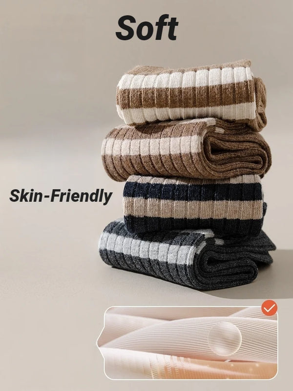 A stack of soft, skin-friendly casual striped men's socks in beige, brown, and gray tones.