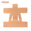 A beige, die-cut piece of kinesiology tape shaped like a cross for shoulder support.