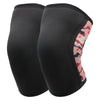 A pair of black knee sleeves with a pink and orange patterned trim for weightlifting.