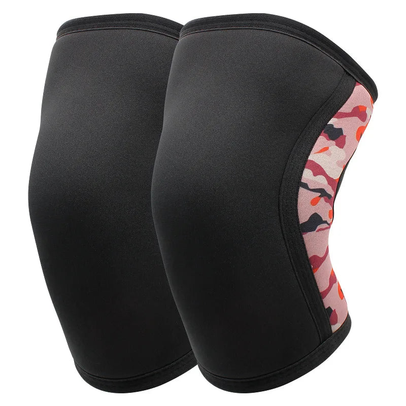 A pair of black knee sleeves with a pink and orange patterned trim for weightlifting.