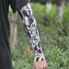 Close-up of a person wearing black ice silk tattoo sleeves with a black and white floral pattern.