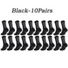 A row of ten pairs of black athletic grip socks.