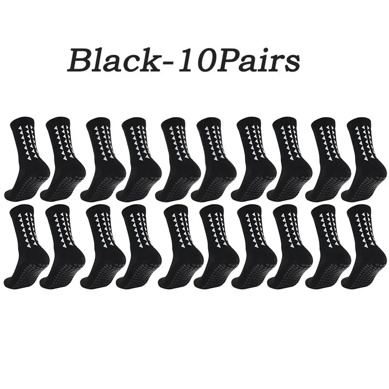 A row of ten pairs of black athletic grip socks.