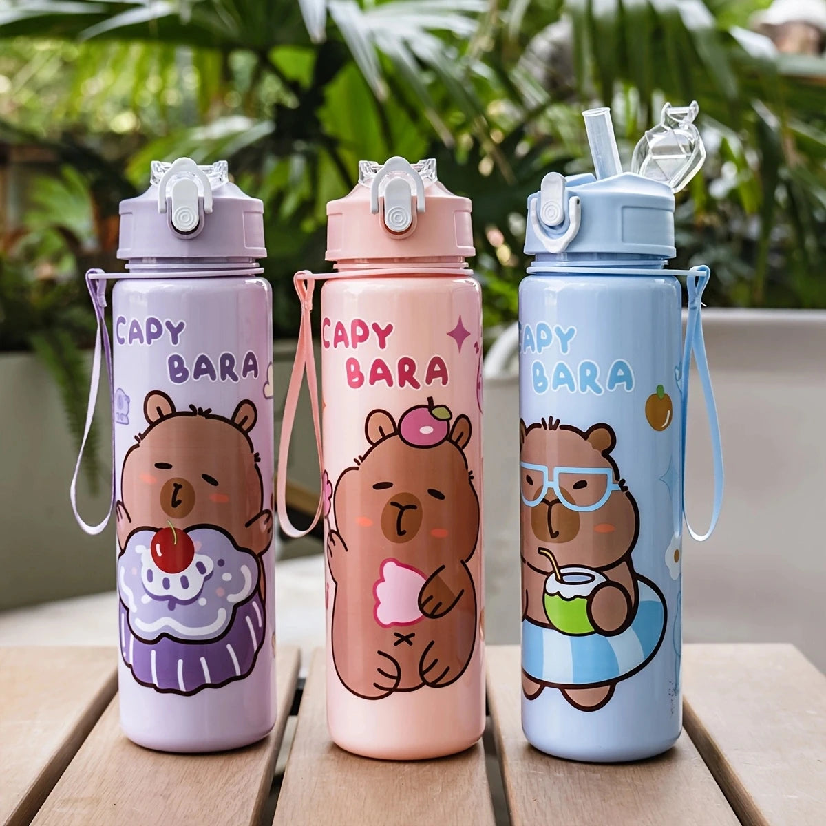 Three colorful cartoon drinking water bottles with straws in purple, pink, and blue.