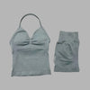 A light gray women's seamless fitness set consisting of a cropped top and matching shorts.