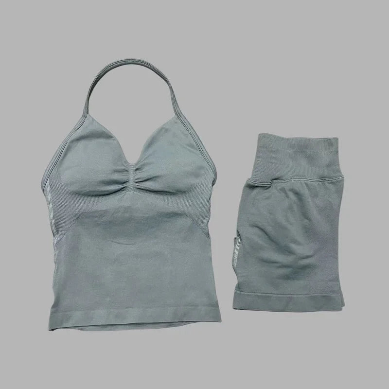 A light gray women's seamless fitness set consisting of a cropped top and matching shorts.