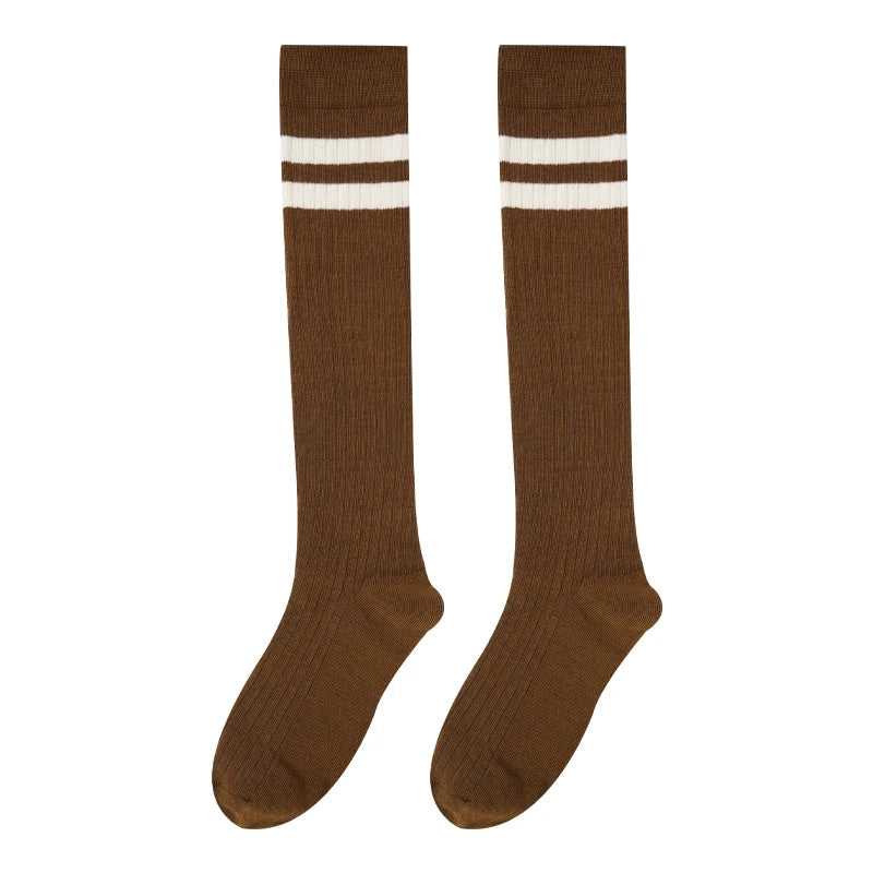A pair of brown cotton knee high socks with white stripes