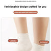 Close-up of white speckled elastic ribbed socks worn on a leg.
