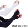 A pair of black and white UV protection cooling arm sleeves being worn on an arm.