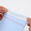A hand is holding a light blue UPF 50+ cool sleeve for outdoor sports, showing the elastic cuff.