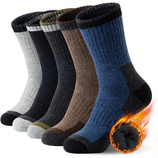A stack of dark and earthy colored merino wool hiking socks with a glowing effect.