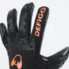 A close-up view of black Defigo goalkeeper gloves with orange accents.
