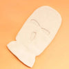 A cream-colored tactical knit balaclava beanie hat lying on an orange background.