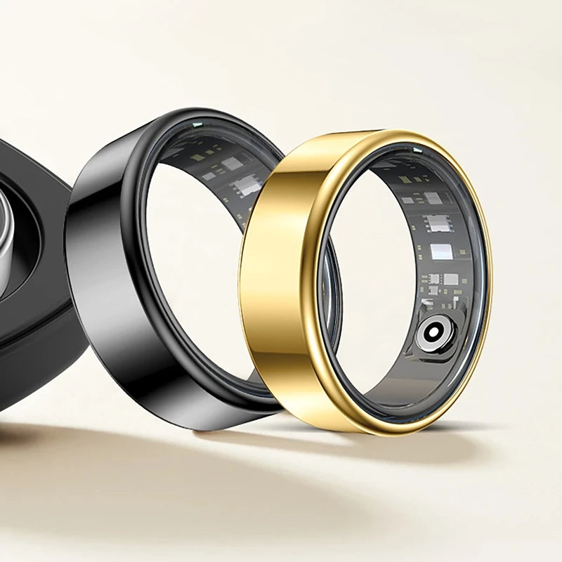 A close-up view of a black and gold smart health ring fitness tracker, showing the inner sensor mechanism.