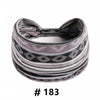 A black and gray patterned fabric turban headband with a zipper detail.