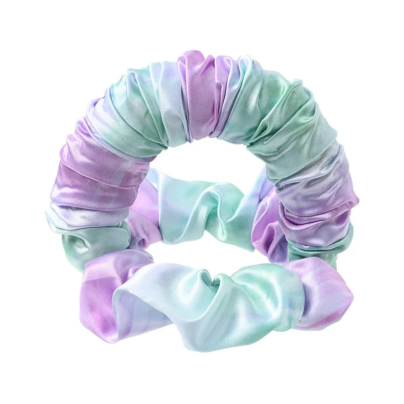 A headband made of silky, draped fabric in shades of lavender and mint green.